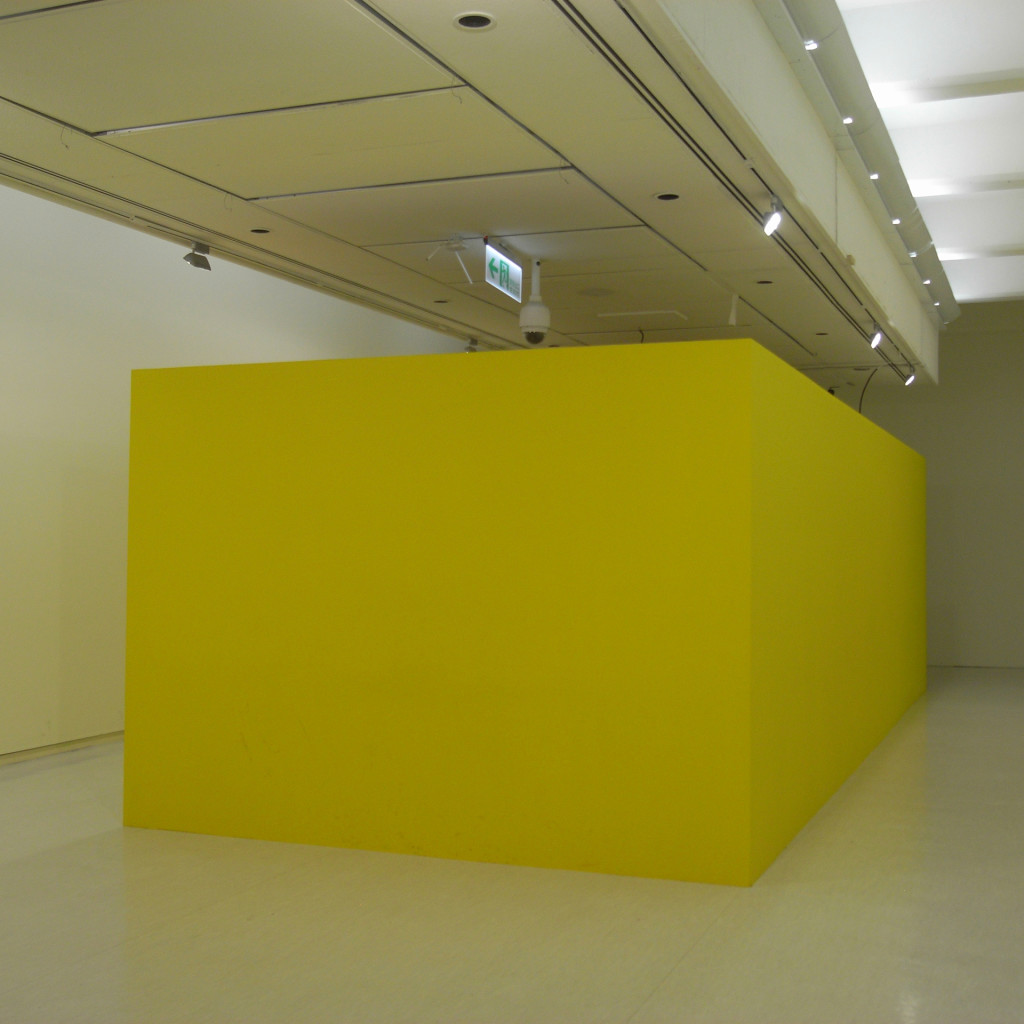 Mika Rottenberg: "Bowls Balls Souls Holes": The yellow outside of the space where the artwork was projected inside.